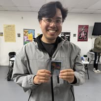 A smiling CardHouse collector showing his card pull